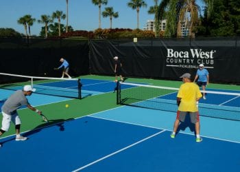 Residents playing a game of Pickleball on two of Boca West's Pickleball courts