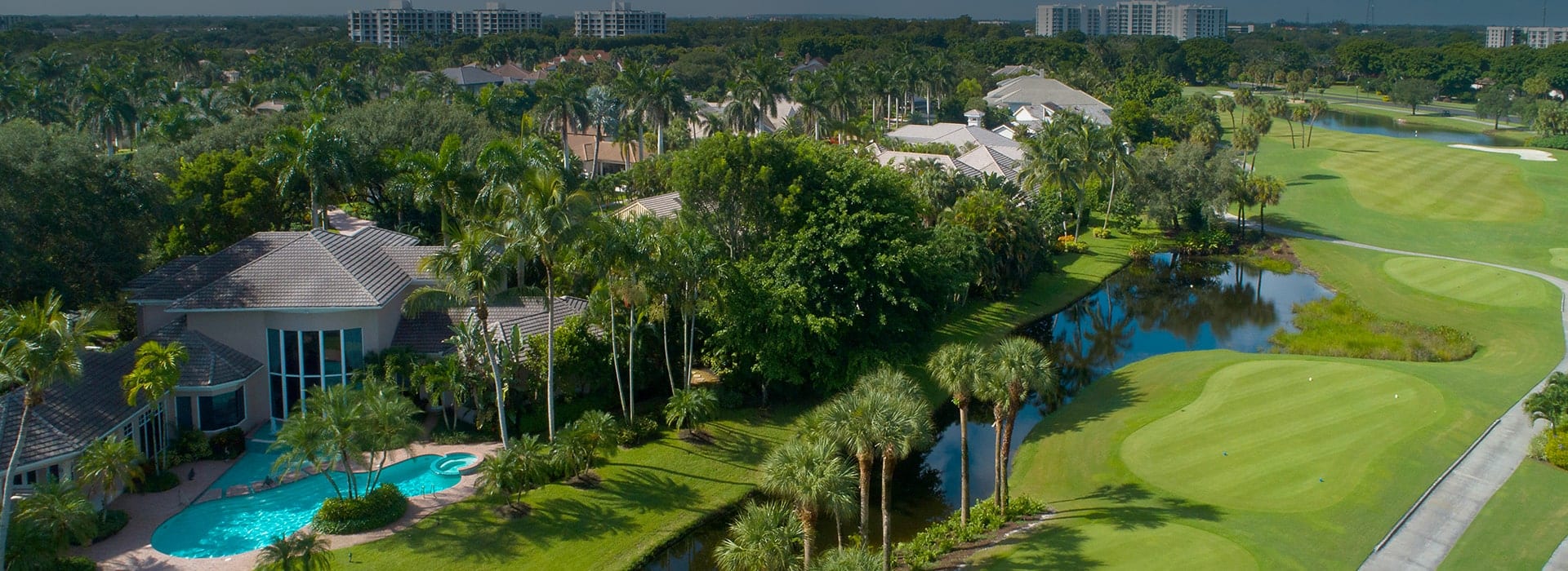 Oakbrook custom-build homes in Boca West with lush landscaping and golf course views