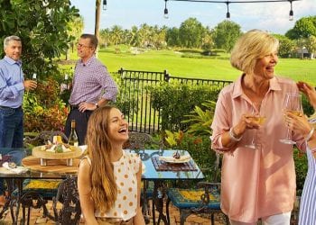 Men and women in backyard of Boca West Country Club home