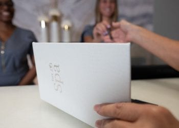 Women signing for her service at Boca West Spa Check-In Station