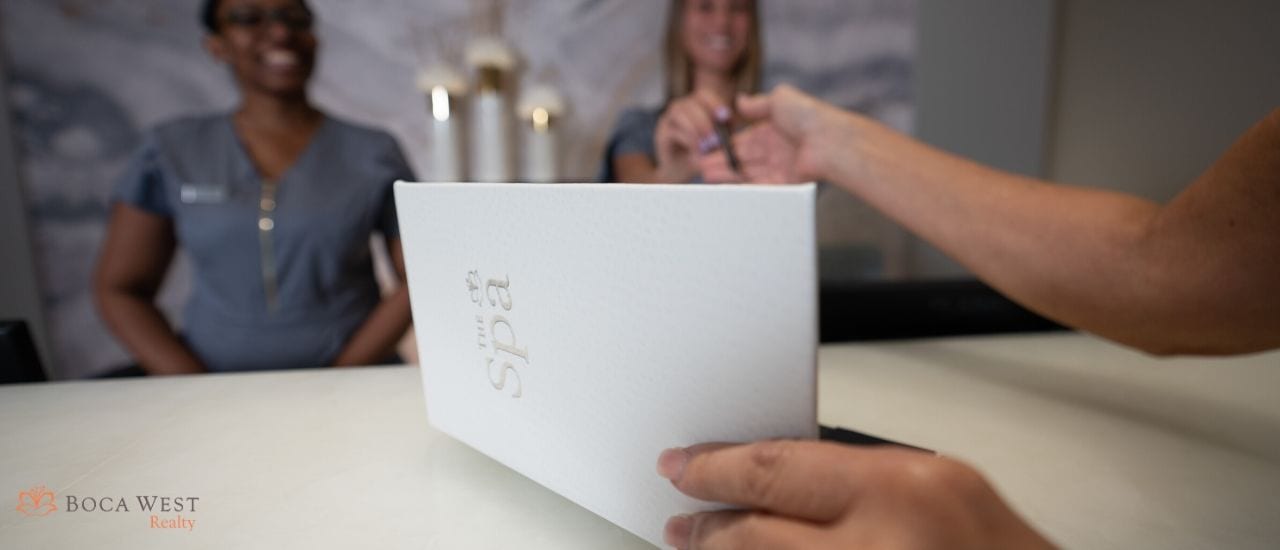 Women signing for her service at Boca West Spa Check-In Station