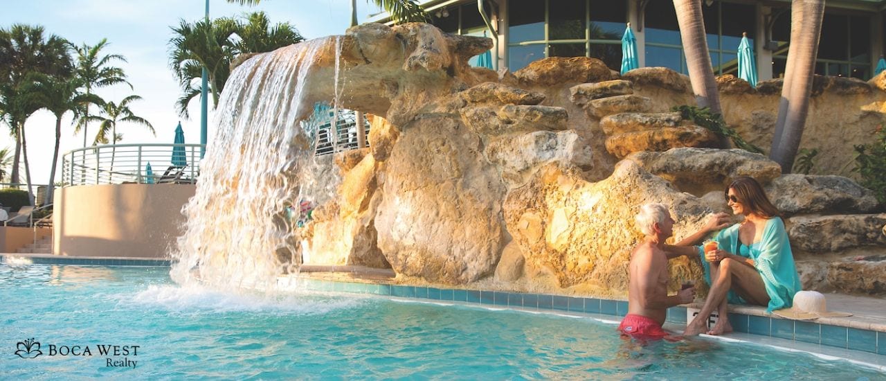 Couple at Boca West Pool beside waterfall