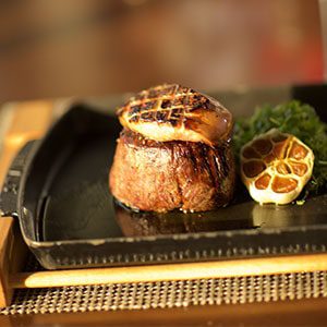A delicious steak on the plate with garlic