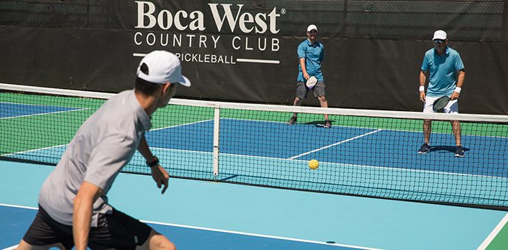 three people playing pickleball at Boca West
